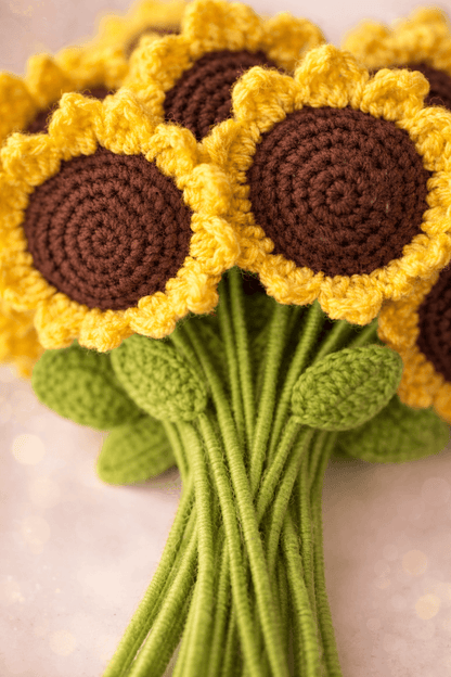 Bouquet of crocheted sunflowers with yellow petals and brown centers on a light background.